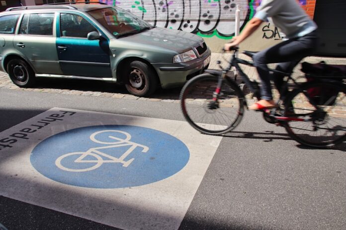 a person riding a bike on a city street