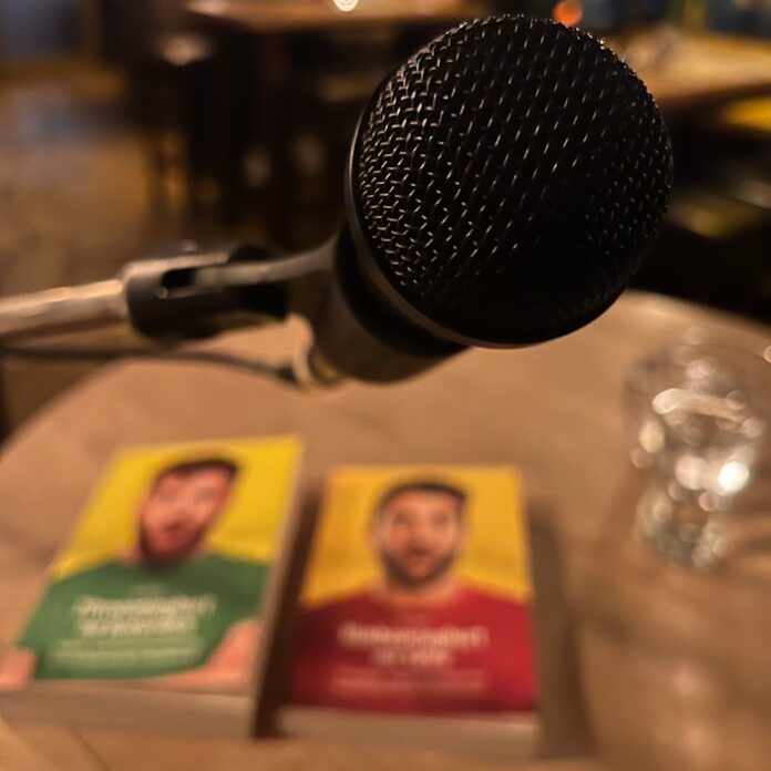 a microphone and two pamphlets on a table